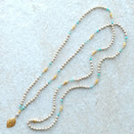 Shivaloka Talusi Devi handknotted mala created with 216 beads ( 2 x 108) in an assortment of tulsi wood beads, amazonite, and pink opal; strung on silk with petal-shaped, 22k gold vermeil pendant.  Mala length: 114 cm / 45” , Sanskrit meaning: Tulsi goddess.