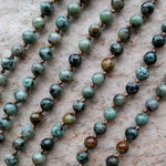 ZenStones handknotted African Turquoise mala necklace with copper buddha pendant. Necklace length approximately 34" or 86cm.