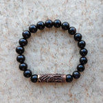 The ZenStones Inner Truth Mala Bracelet designed with a handcrafted bronze focal piece and natural black Obsidian beads.