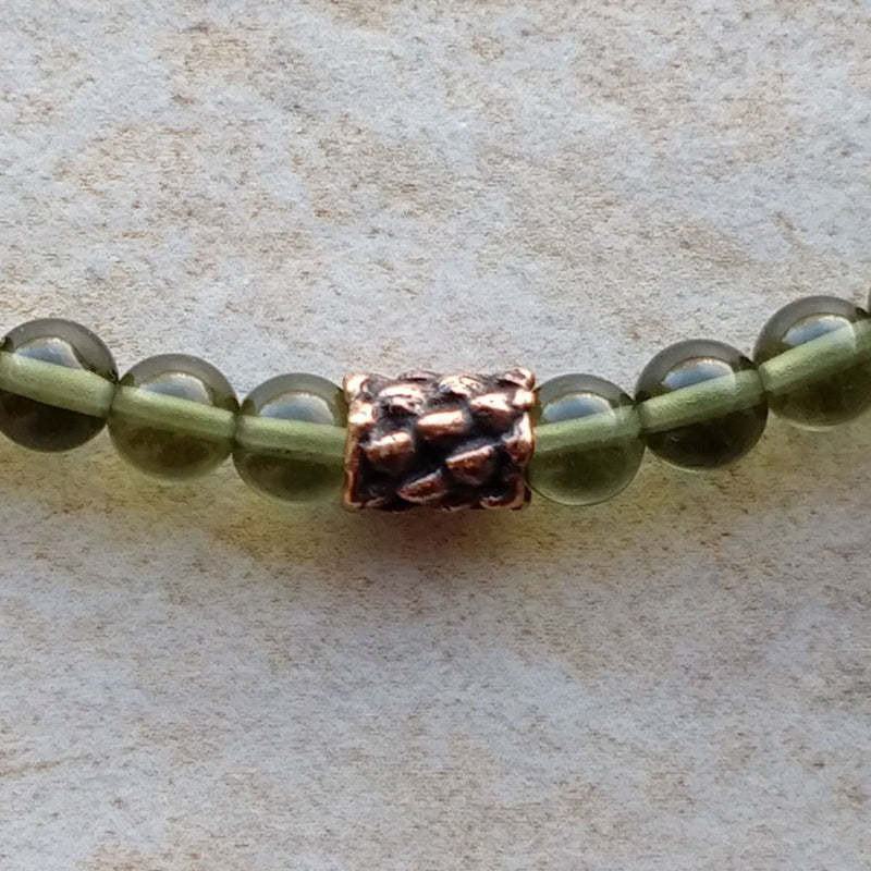 The ZenStones Wanderlust Mala Bracelet combines high-grade natural Czech Moldavite with dark Rosewood beads, and a handcrafted red bronze focal piece.
