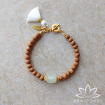 The ZenStones Harmony Mala Bracelet created with fragrant Sandalwood and pale green Chalcedony.