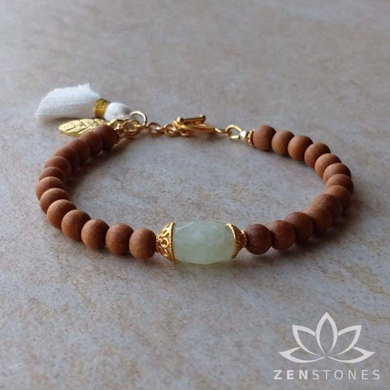 The ZenStones Harmony Mala Bracelet created with fragrant Sandalwood and pale green Chalcedony.